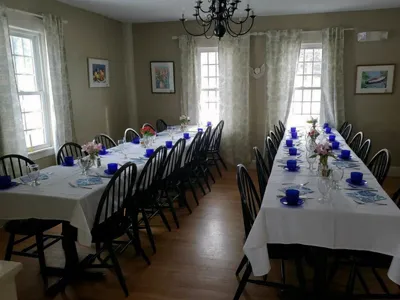 A long table with many chairs and plates on it